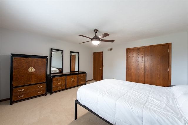 bedroom featuring ceiling fan and light carpet