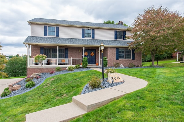 front of property featuring a porch and a front yard