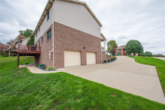 view of home's exterior featuring a garage, a deck, and a yard