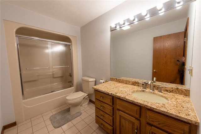 full bathroom with tile patterned flooring, vanity, bath / shower combo with glass door, and toilet