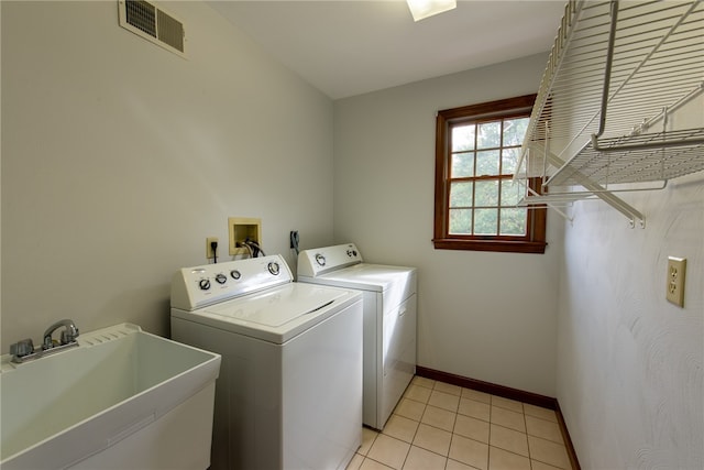 laundry room with washer and dryer, sink, and light tile patterned floors