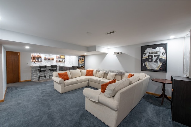 living room featuring dark colored carpet and indoor bar