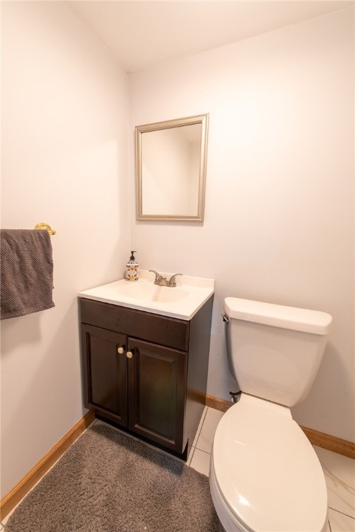 bathroom with vanity, toilet, and tile patterned floors