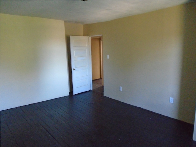 spare room featuring dark hardwood / wood-style flooring