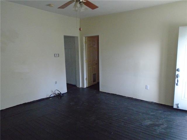 empty room with dark hardwood / wood-style floors and ceiling fan