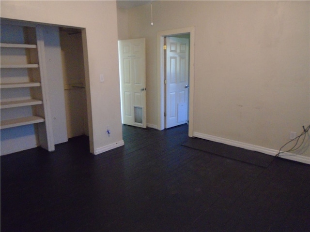 unfurnished bedroom with dark hardwood / wood-style floors