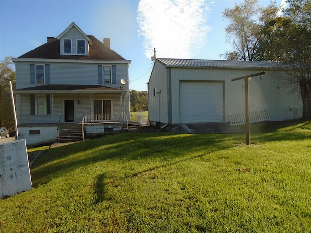 back of property featuring a yard, covered porch, and a garage