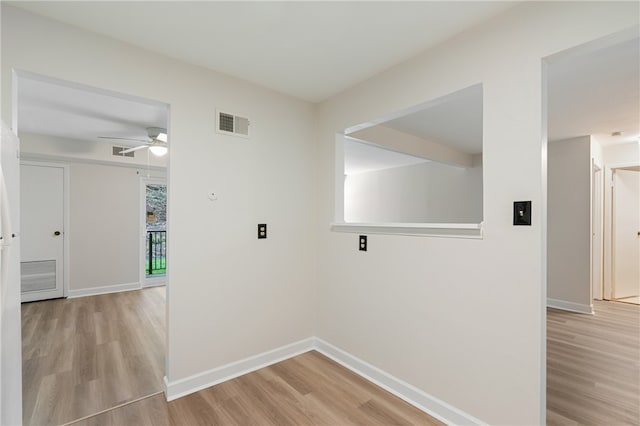 washroom with ceiling fan and light hardwood / wood-style flooring