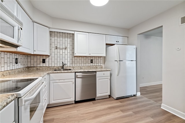 kitchen with decorative backsplash, white appliances, light hardwood / wood-style flooring, and white cabinetry