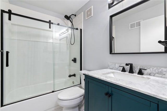 full bathroom with combined bath / shower with glass door, vanity, and toilet