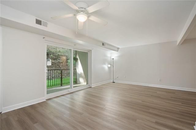 unfurnished room with hardwood / wood-style floors and ceiling fan