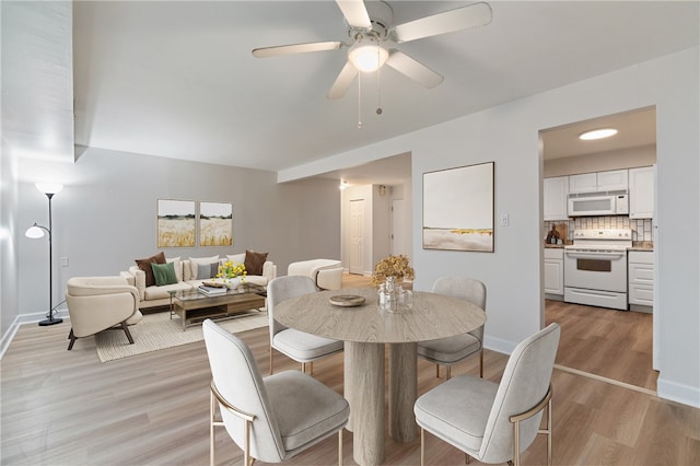 dining room featuring light hardwood / wood-style floors and ceiling fan