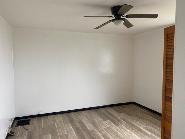 spare room with wood-type flooring and ceiling fan