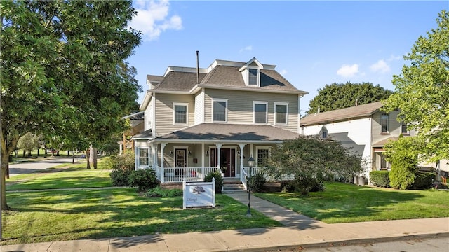 view of front of property with covered porch and a front yard