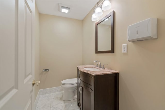 bathroom featuring vanity and toilet