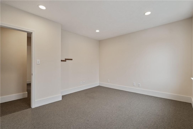 empty room featuring dark colored carpet