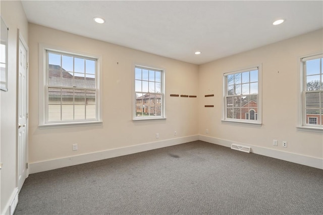 carpeted empty room featuring plenty of natural light