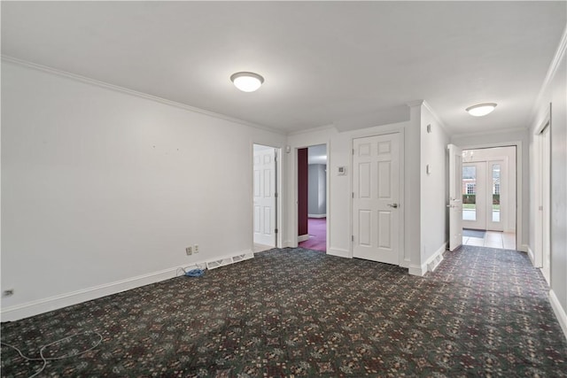 empty room featuring french doors and ornamental molding