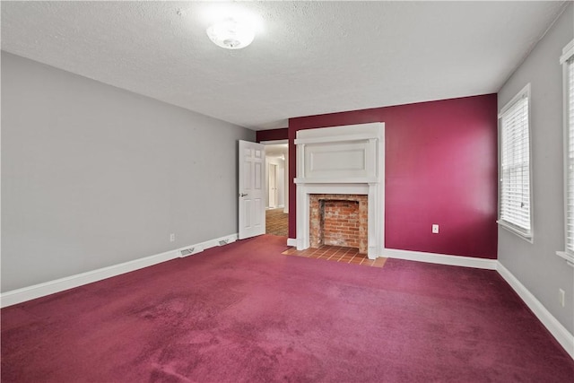 unfurnished living room featuring carpet flooring and a textured ceiling