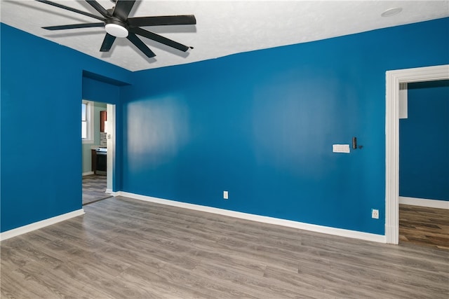 spare room featuring hardwood / wood-style flooring and ceiling fan