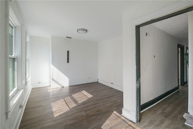 unfurnished room featuring dark wood-type flooring