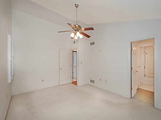 carpeted spare room featuring high vaulted ceiling and ceiling fan