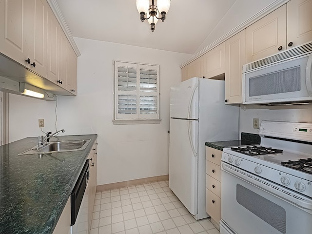 kitchen featuring white appliances, dark stone countertops, vaulted ceiling, sink, and light tile patterned floors