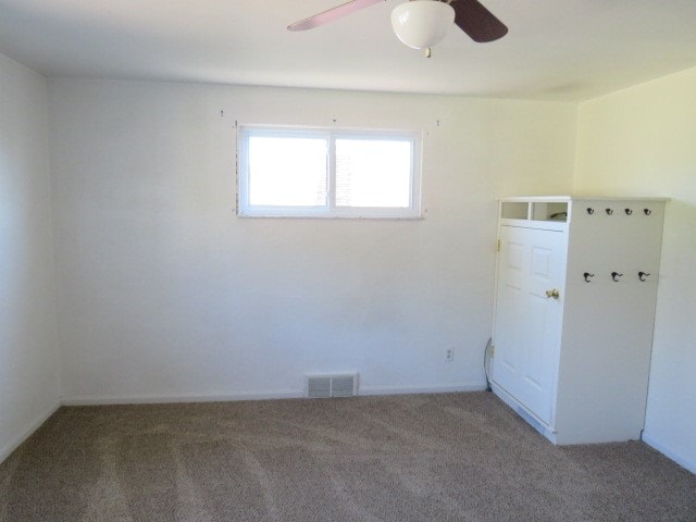 empty room with carpet flooring and ceiling fan