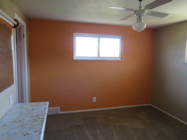 carpeted empty room with ceiling fan