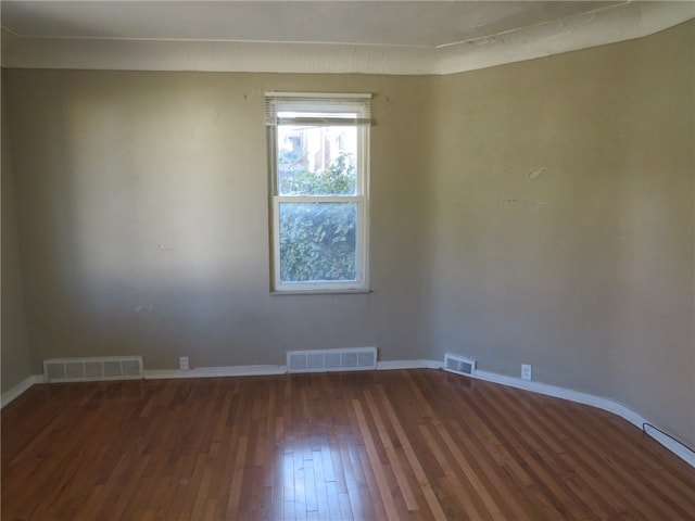 spare room with dark wood-type flooring