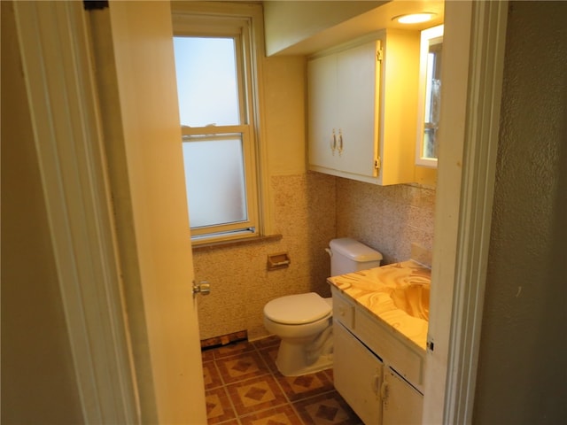 bathroom with vanity, tile walls, toilet, and tile patterned floors