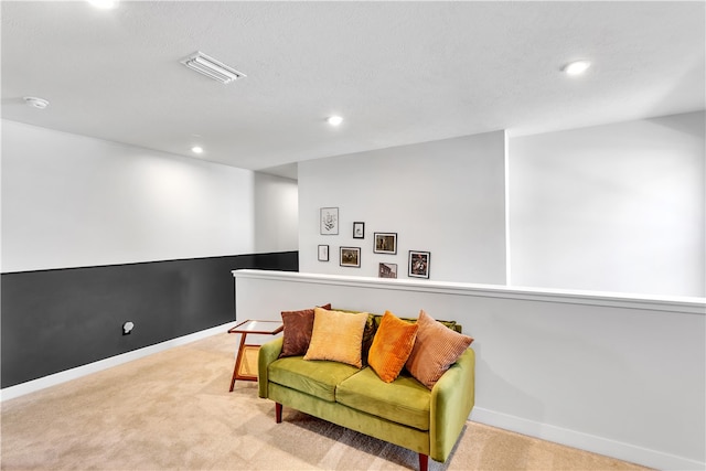 sitting room featuring light colored carpet