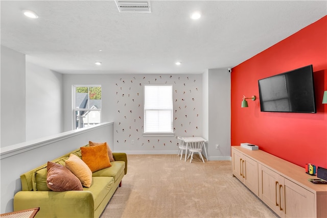 living room with light colored carpet and a textured ceiling