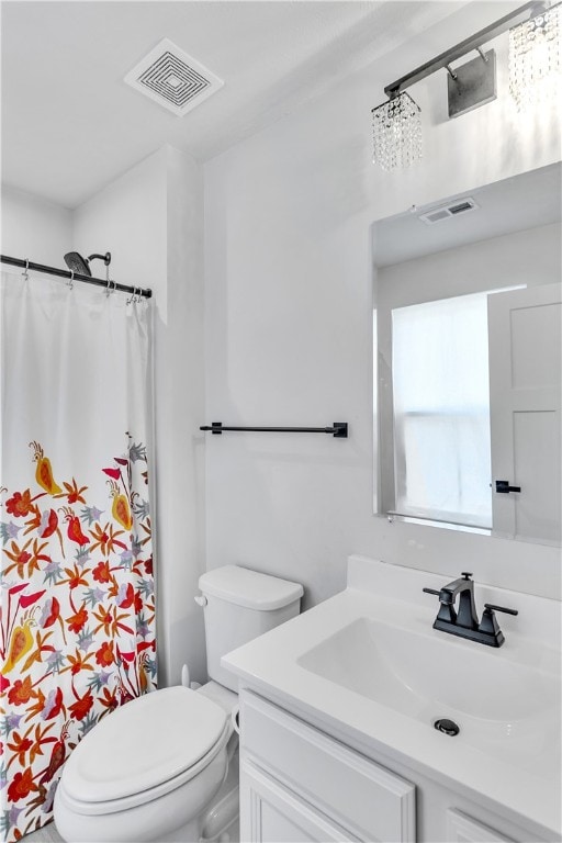 bathroom with walk in shower, an inviting chandelier, vanity, and toilet