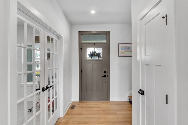 entryway with light wood-type flooring and french doors