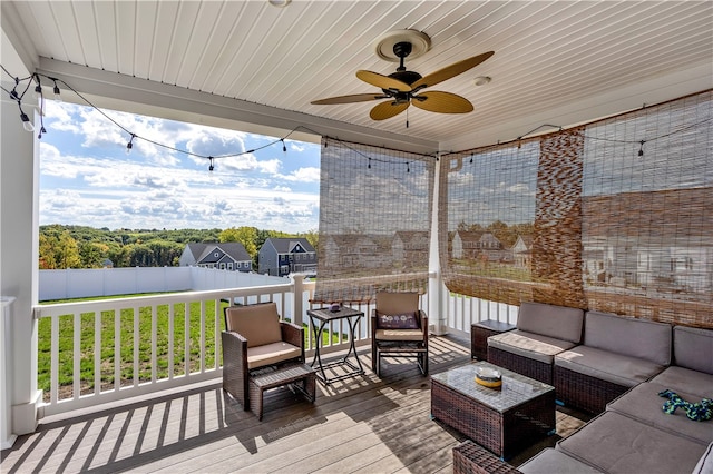 wooden deck featuring an outdoor hangout area and ceiling fan