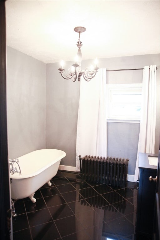 bathroom with radiator heating unit, vanity, a bath, tile patterned flooring, and an inviting chandelier