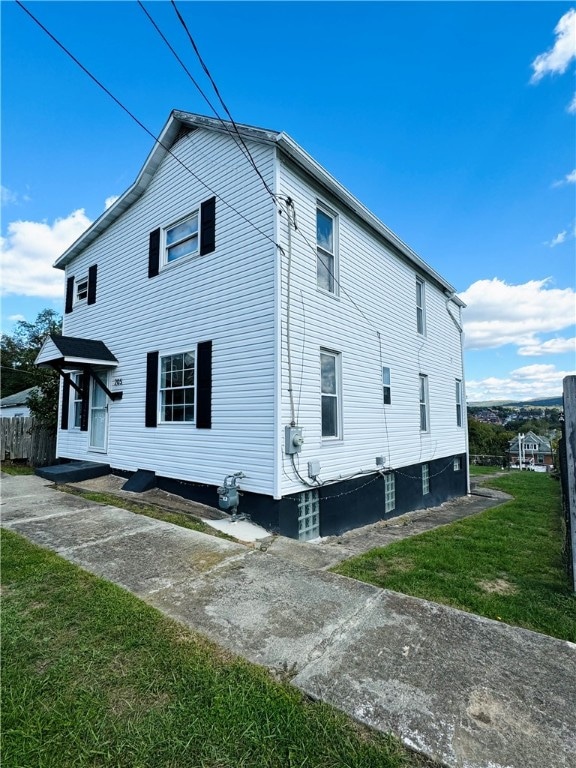 view of side of property with a yard