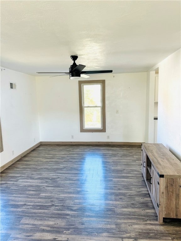 spare room with ceiling fan and dark hardwood / wood-style flooring