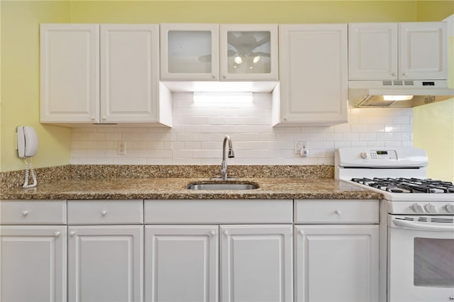 kitchen featuring gas range gas stove, white cabinetry, and sink