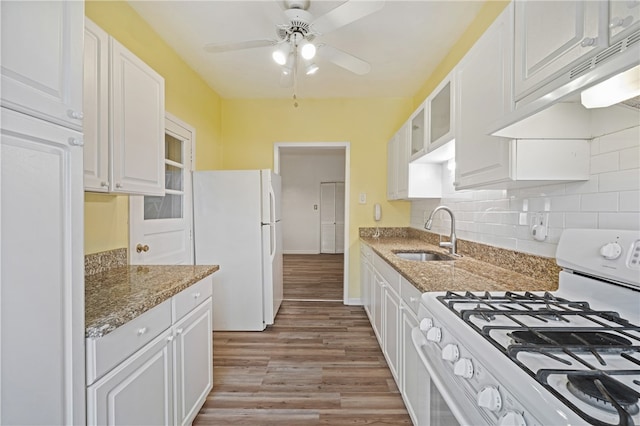 kitchen featuring white appliances, sink, light hardwood / wood-style floors, white cabinetry, and stone counters