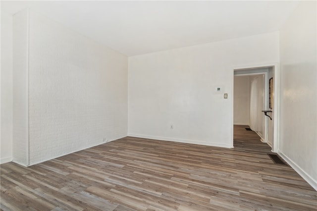 unfurnished room with hardwood / wood-style floors