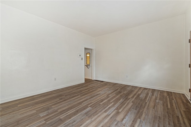 empty room with dark wood-type flooring