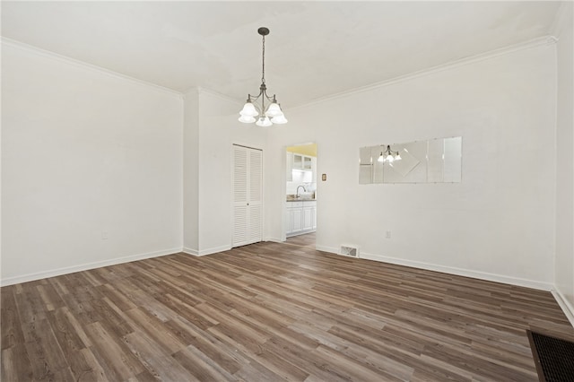 empty room with ornamental molding, dark wood-type flooring, and an inviting chandelier