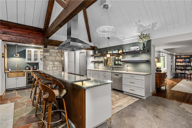 kitchen with pendant lighting, white cabinets, tasteful backsplash, appliances with stainless steel finishes, and hardwood / wood-style floors