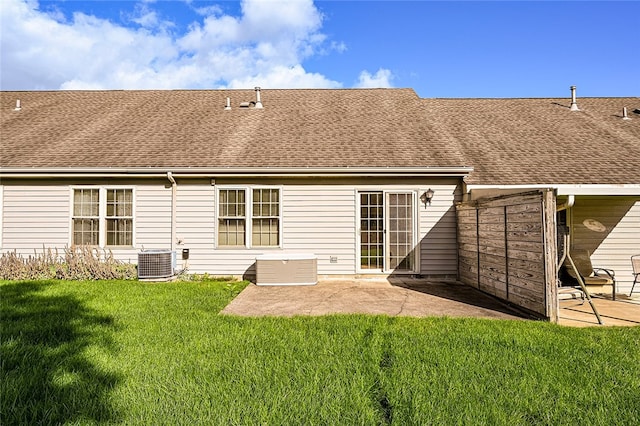 back of house featuring central air condition unit, a patio area, and a yard