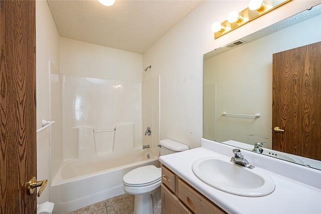 full bathroom featuring vanity, a textured ceiling, shower / washtub combination, tile patterned flooring, and toilet