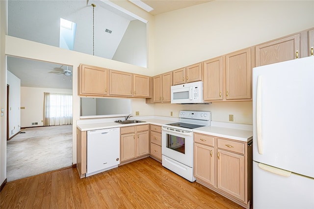 kitchen featuring light brown cabinets, white appliances, high vaulted ceiling, sink, and light hardwood / wood-style floors