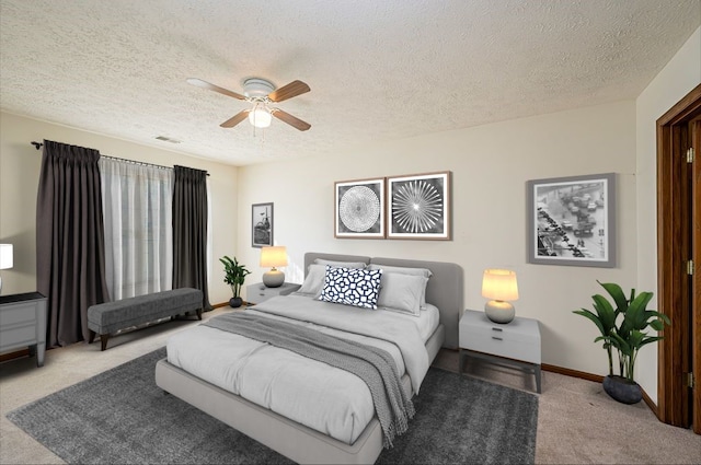 bedroom with light carpet, a textured ceiling, and ceiling fan