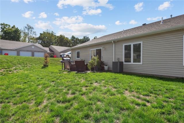 view of yard featuring a garage and cooling unit